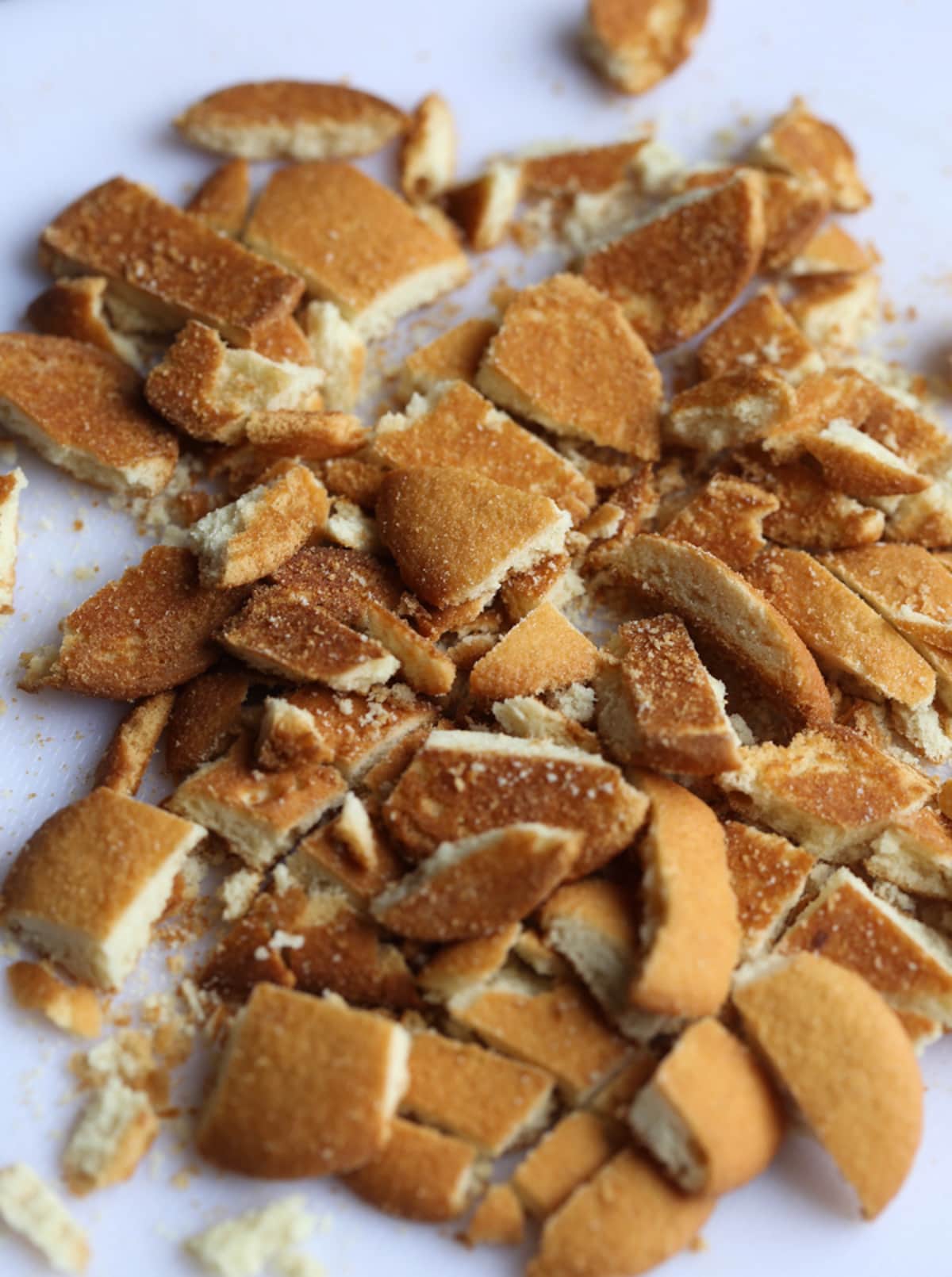 Crushed nilla wafers on a white countertop.