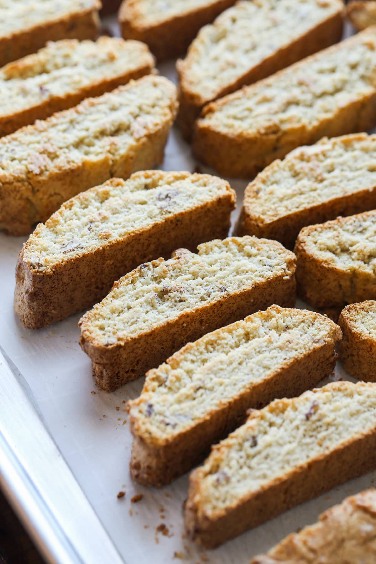 Rows of sliced almond cookies.