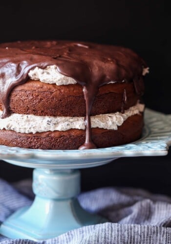 A Chocolate Cake with Oreo Frosting Sitting on Top of a Light Blue Cake Stand