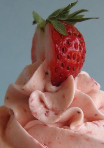 Close-up of strawberry frosting with a strawberry on top