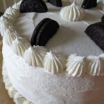 A Chocolate Cake with Vanilla Buttercream Frosting and Oreo Cookies on Top