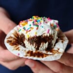 Holding an ice cream cupcake and unwrapping it