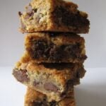 A stack of chocolate chip cookie bars on a white surface