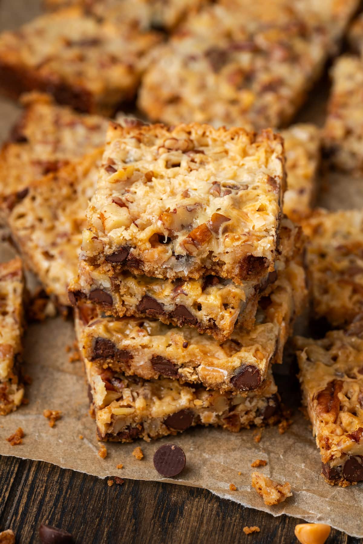 Close up of a stack of magic bars surrounded by more bars on a piece of parchment paper.