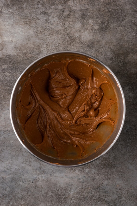 Nutella brownie batter in a metal mixing bowl.