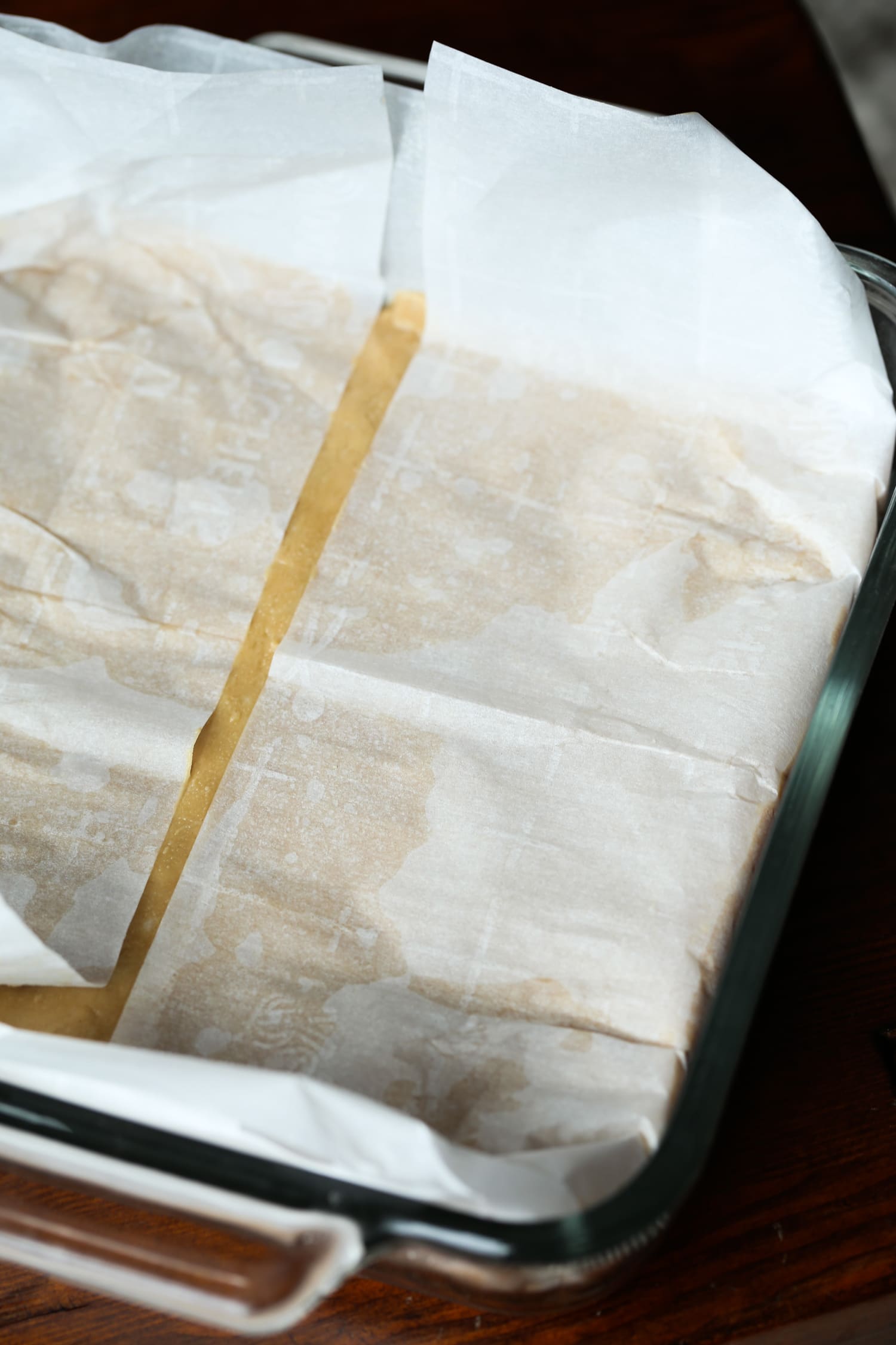 Peanut butter fudge in a backing tray covered in parchment paper.