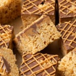 Overhead view of assorted peanut butter rice krispie treats drizzled with melted peanut butter chips.