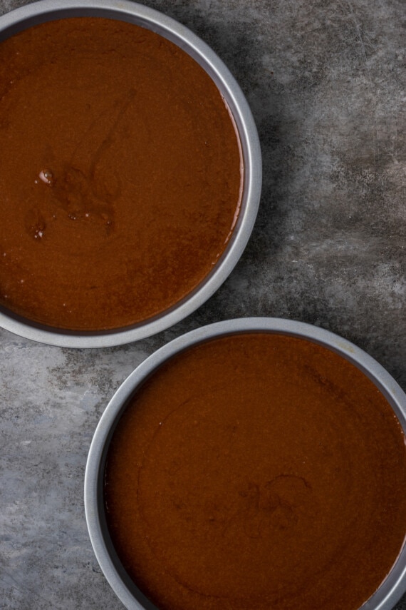 Chocolate cake batter divided between two 9-inch cake pans.