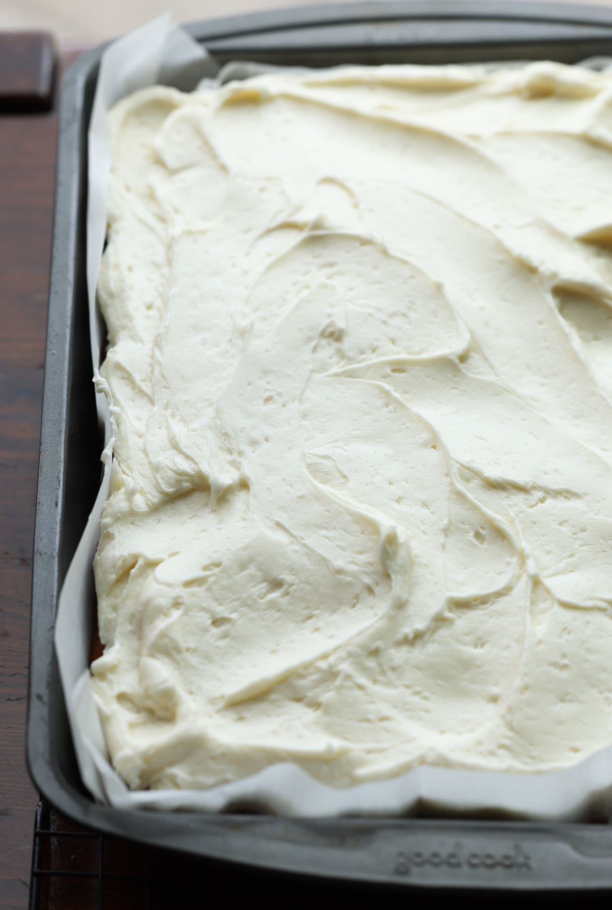 a sheet cake topped with cream cheese frosting in a 9x13 pan