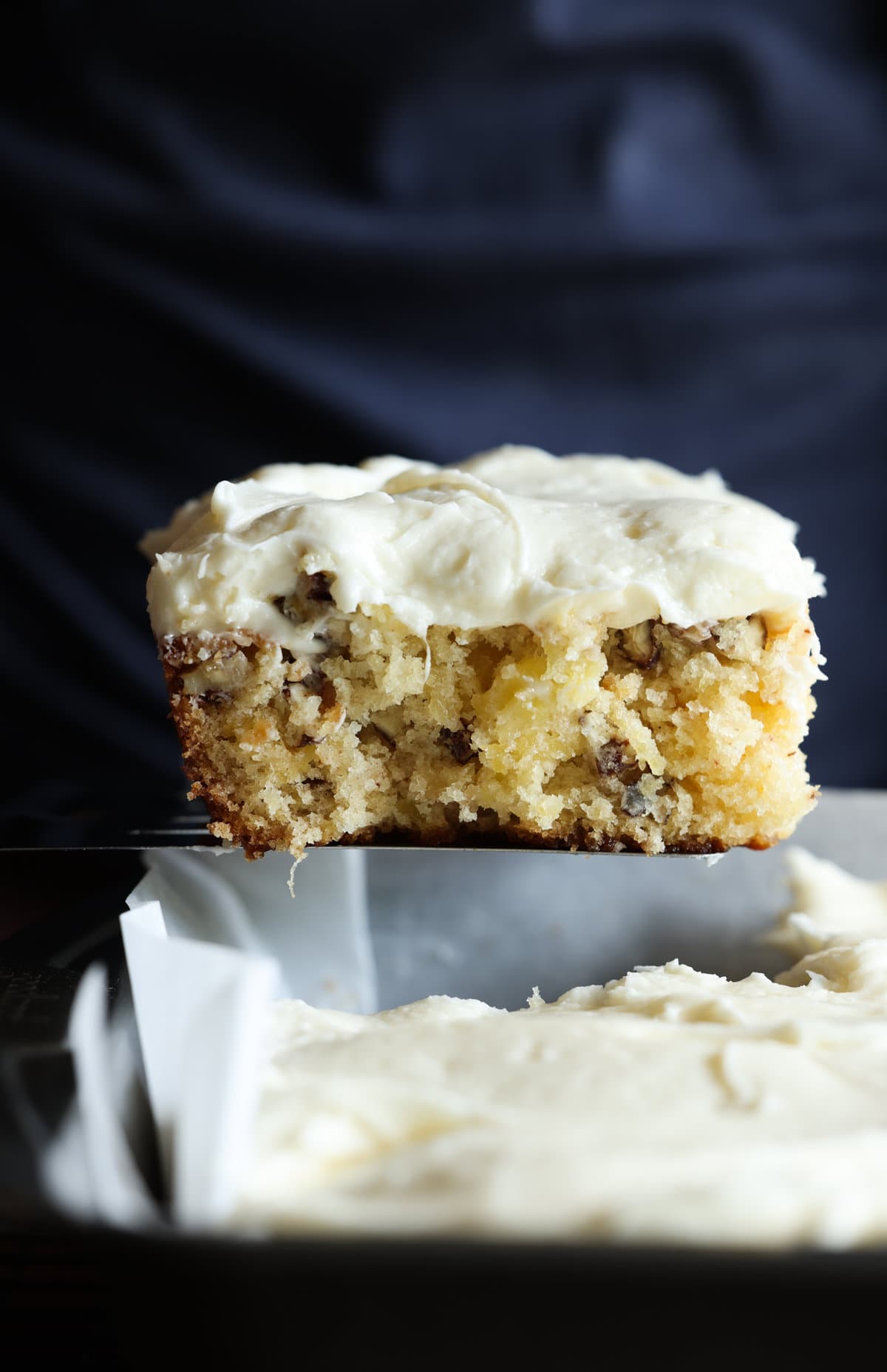 A slice of pineapple cake on a metal spatula