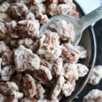 Sour Cream Candied Pecans in a bowl with a spoon to scoop