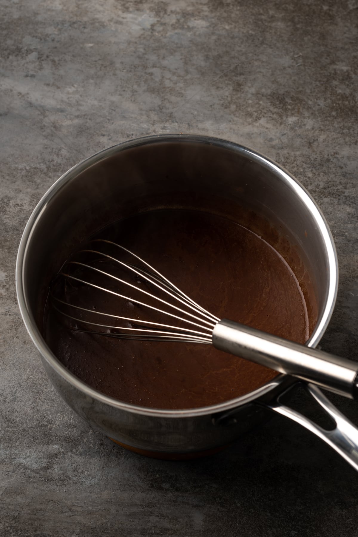 Cocoa mixture for chocolate sheet cake whisked together in a saucepan.