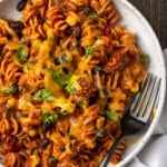 Overhead view of taco pasta in a white bowl with a fork.