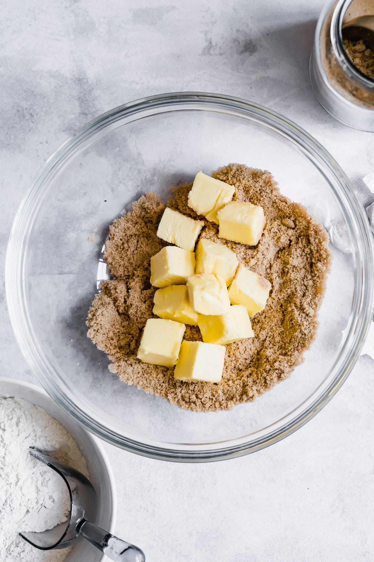 Brown sugar and butter cubes in a bowl.